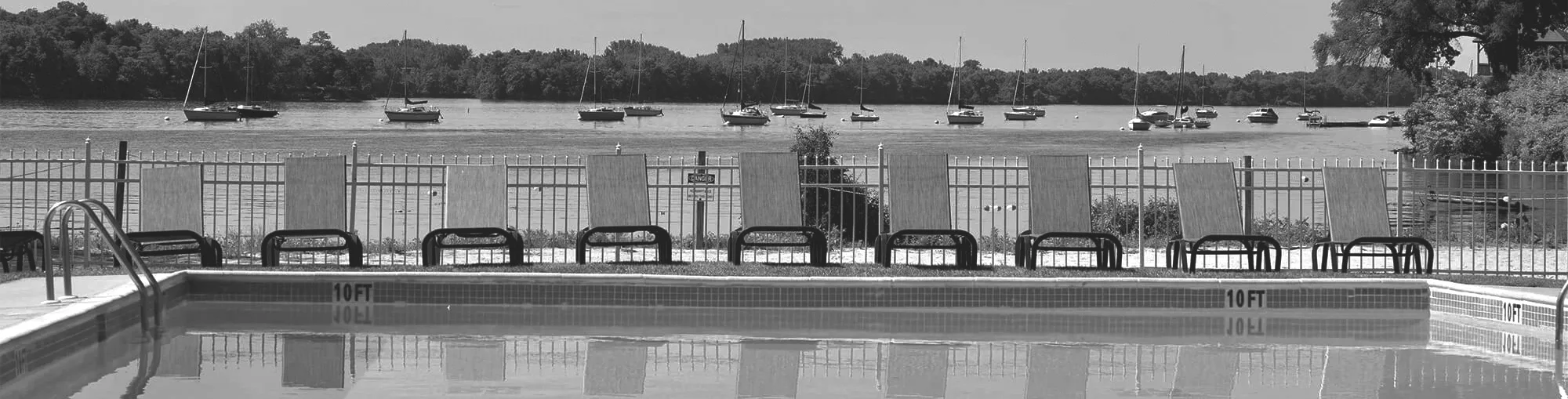 Black and white photo of Line of boats on the Delaware river besides the warm blue pool at Salem Harbour